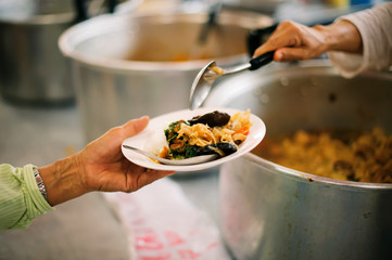 Philanthropists donate food to the poor, share food, help each other in society.