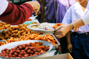 Philanthropists donate food to the poor, share food, help each other in society.