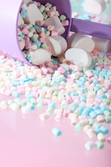 Fototapeta na wymiar Violet pail with various marshmallows.