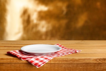 White circle Plate on napkin on wooden table