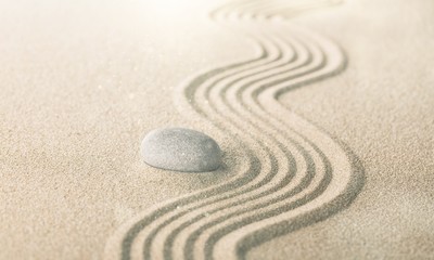 zen garden with raked sand and a smooth stone