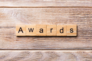 AWARDS word written on wood block. AWARDS text on wooden table for your desing, concept