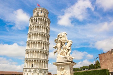 Fototapeta na wymiar Fontana dei Putti and Leaning Tower of Pisa (Torre pendente di Pisa) in Piazza dei Miracoli (Square of Miracles) in Pisa, Italy.