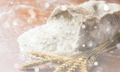 Wheat ears and flour on  background