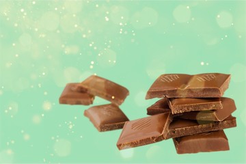 Dark chocolate blocks and bieces isolated on white background