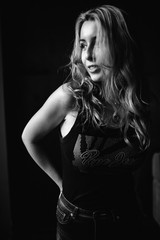 Portrait of a beautiful fashionable woman, blonde, jeans, brown background