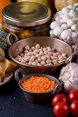 Still life food set on dark background. Concept shealthy eating. Lentils, nut, cheese, garlic, mushrooms, cherry tomato.