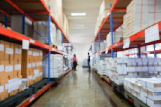 Blurry shelves in the warehouse background.