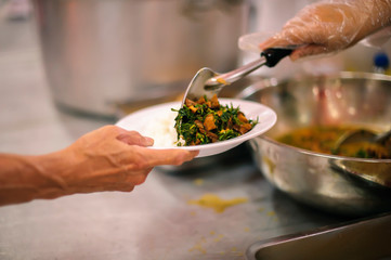 The hands of the hungry get food from the hands of volunteers : concept of hunger poverty