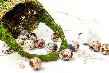 Easter decoration with eggs and basket on white wooden background. Easter egg hunt concept. Flat lay top view copy space. Spring greeting card