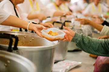 Hands holding food: Hunger problems are assisted by people in society.