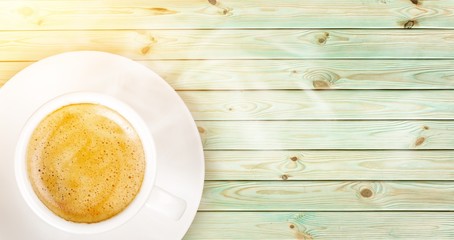 Cup of coffee on wooden background
