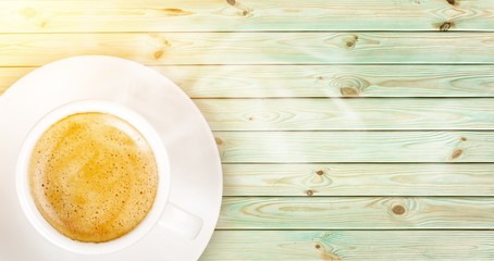 Cup of coffee on wooden background