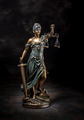 Photography of bronze themis sculpture, femida or justice goddess on dark background