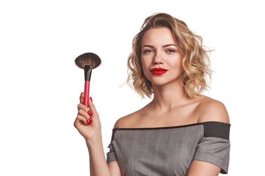 Fashionable woman stylist standing posing with makeup brush