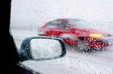 Detail of rear-view mirror in the rainy weather