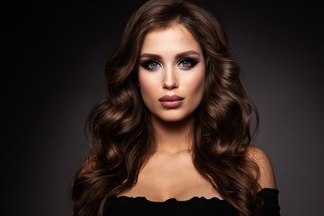 Fototapeta premium Beautiful woman with professional make up and curly hair