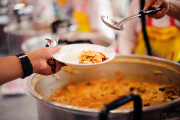 Volunteers are giving food to the homeless poor :  the concept of humane
