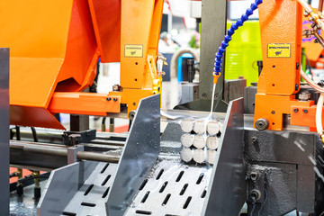 Many round shaft steel is being cutting by automatic continuous and high speed horizontal band saw...