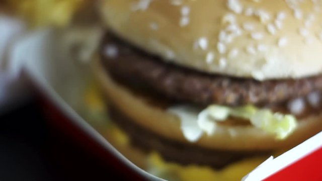 Yummy delicious juicy big mac burger in a red meal box, with macro rack focus on it