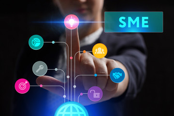 The concept of business, technology, the Internet and the network. A young entrepreneur working on a virtual screen of the future and sees the inscription: SME
