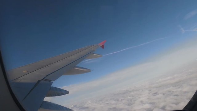 Airplane Interior View of Clouds Through Jet Window