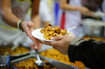 Volunteers donate food to help homeless and hungry people.