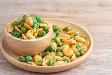 Many types of beans, fried with salt in a wooden plate.