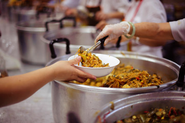 Volunteers have been feeding the homeless, They reach out with love and concern.