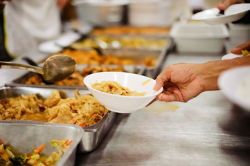 Free food distribution is social activity for helping the homeless people by giving them food.