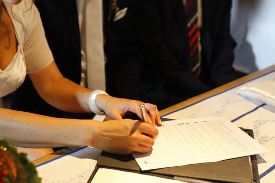 Bride signs wedding document