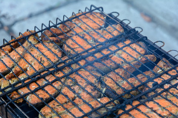 Grilled salmon with lemon and olive oil. Spread salmon on the heated grill and fry on each side until golden brown
