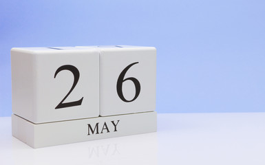 May 26st. Day 26 of month, daily calendar on white table with reflection, with light blue background. Spring time, empty space for text