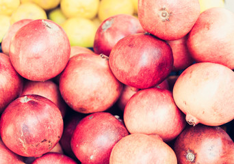 Ripe pomegranates in the fruit market, Catania, Sicily, Italy.
