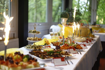 festive table setting with different types of food and fireworks sparklers