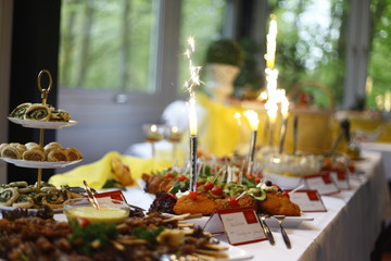 festive table setting with dirfferent plates of food decorated with sparklers firework