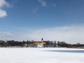 Nesvizh Castle, Belarus in winter as seen from across the frozen pond