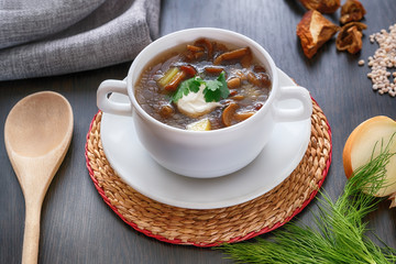 Delicious mushroom soup with parsley close-up on the table. Horizontal top view.