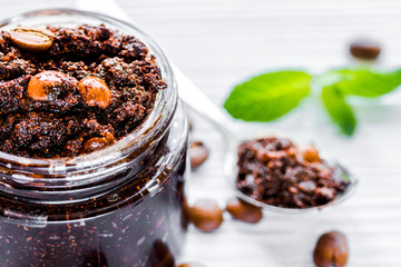 Homemade cosmetics with coffee scrub on white desk background