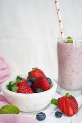 Homemade Strawberry blueberry Smoothie in a tall glass, selective focus