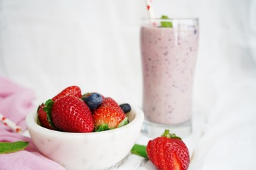 Homemade Strawberry blueberry Smoothie in a tall glass, selective focus