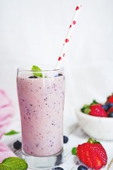 Homemade Strawberry blueberry Smoothie in a tall glass, selective focus