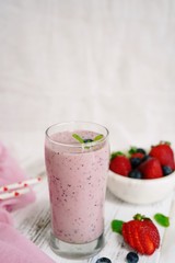 Homemade Strawberry blueberry Smoothie in a tall glass, selective focus