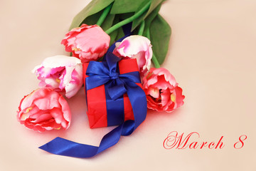pink tulips and decorative gift box with a bow for the holiday of March 8