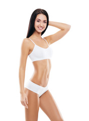 Obraz premium Young, fit and beautiful brunette girl in white swimsuit.