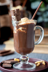 Hot chocolate with cream in a mug on a dark background.