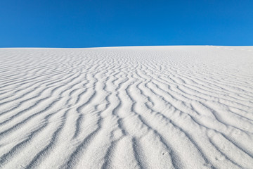 Fototapeta na wymiar Looking up a dune at the rippled sand, in White Sands National Monument
