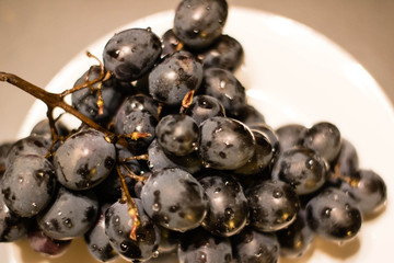 Purple grape on the plate