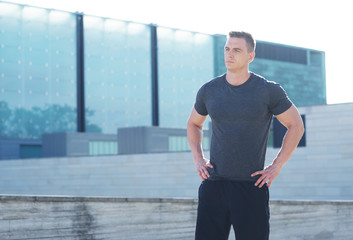 Fototapeta premium Young and sporty man training outdoor in sportswear. Sport, health, athletics.