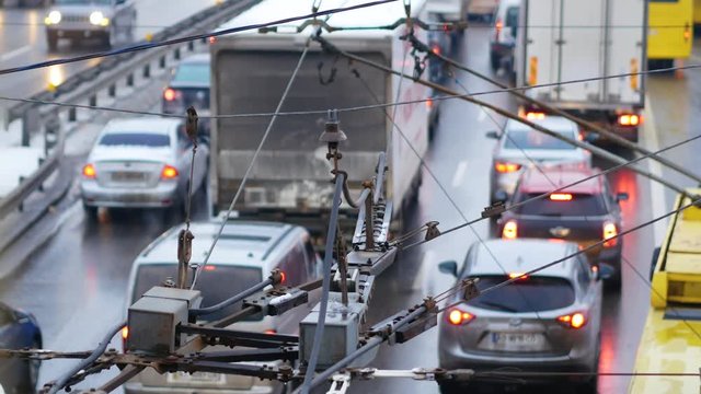 The trolley bus passes through the intersection of overhead wires. Trolleybus arrow. Close up